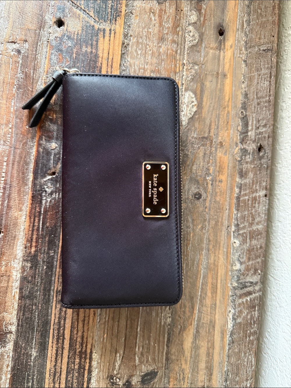kate spade black zip-around nylon wallet with silver plaque